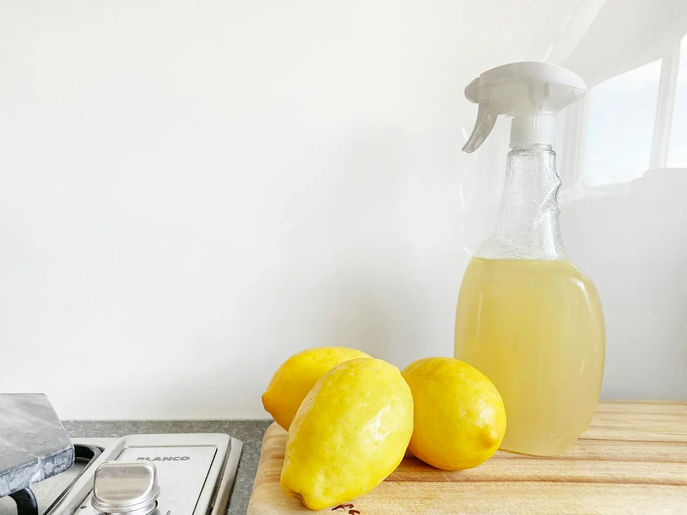Fresh lemon-scented cleaning spray on a bright kitchen counter